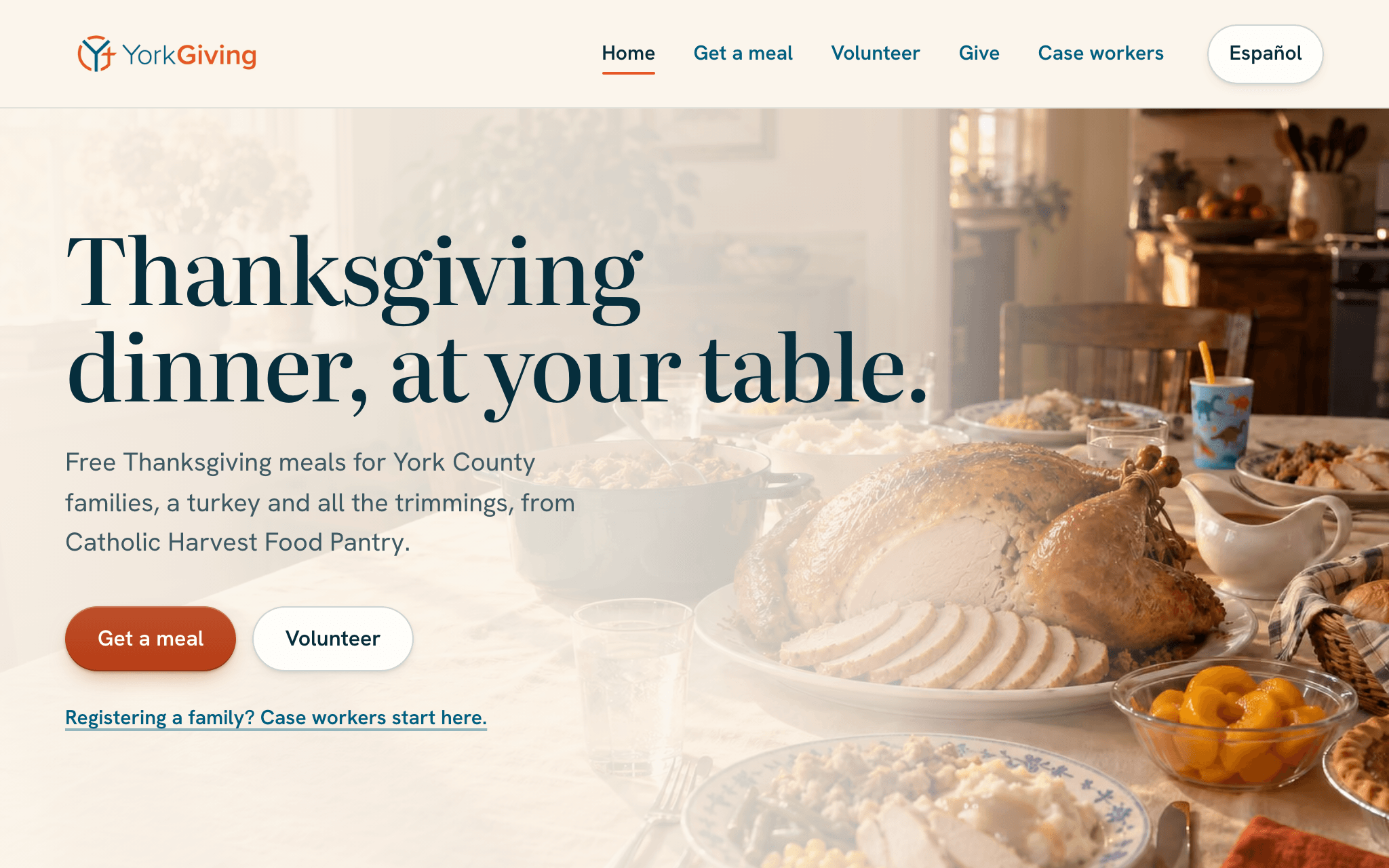 The top of the yorkgiving.com homepage: the headline, a line on the meal and who provides it, buttons to get a meal or to volunteer, and a picture of a Thanksgiving table.